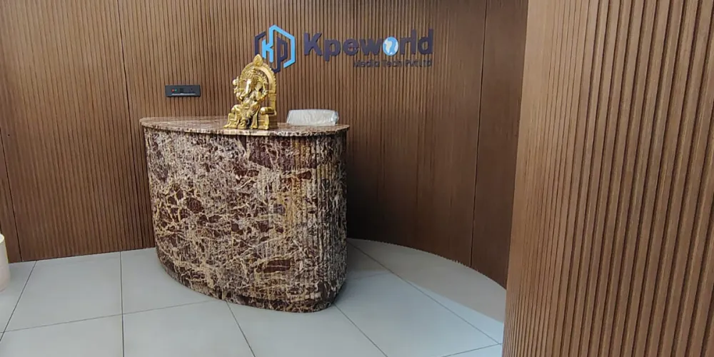 Marble front desk under the Kpeworld logo